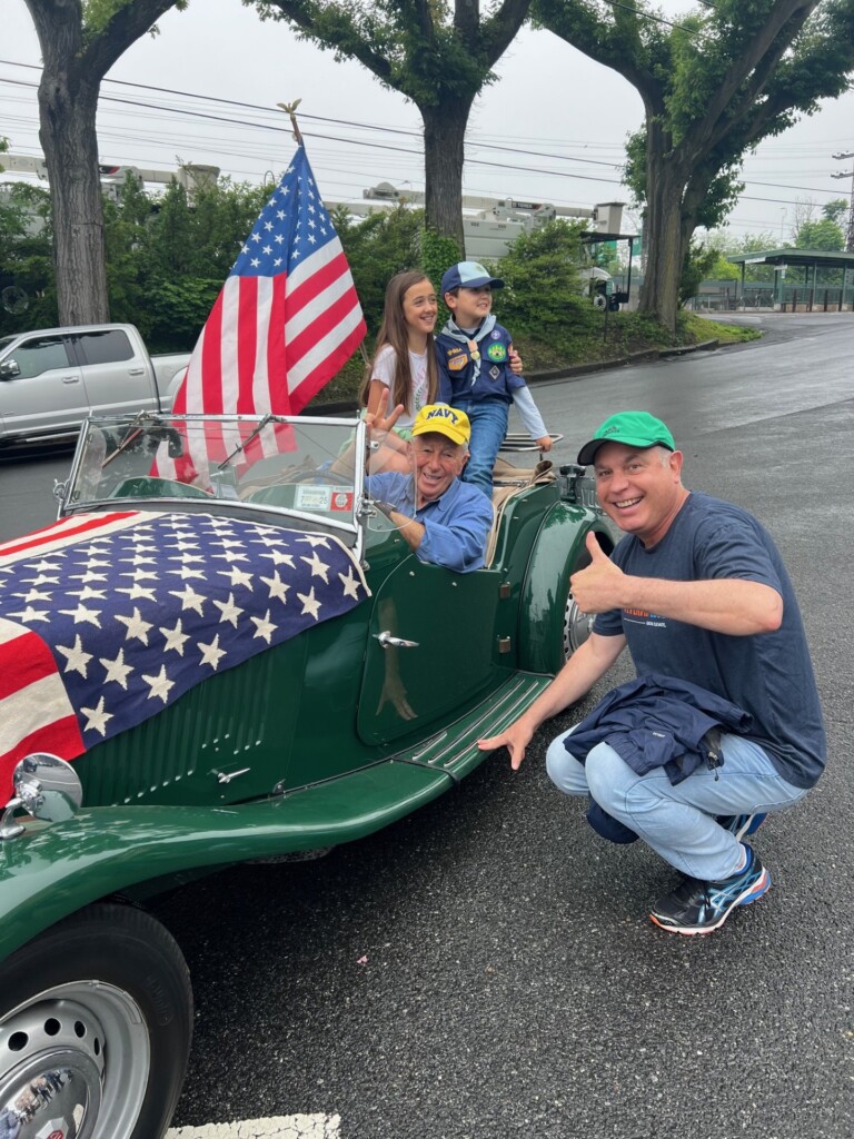 (PHOTO: The Rye Historical Society at the Memorial Day Parade. John Bello (in car) and Andy Gold. Contributed.) 