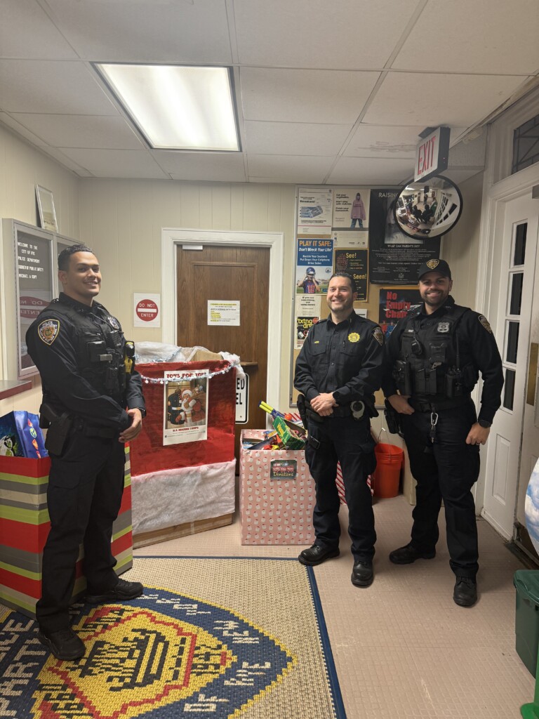 (PHOTO: Rye Police Officer Dangelo Morales, Lieutenant Al Hein and Officer Robert Jones protecting the donations made to the Rye PBA's 2024 Toys for Tots toy drive at Rye Police headquarters. Contributed.)