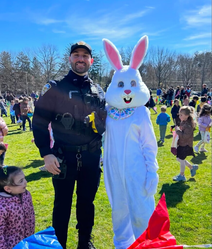 (PHOTO: Rye PD Officer Stefano Silvestri works protective duty with the Easter Bunny. Contributed.)