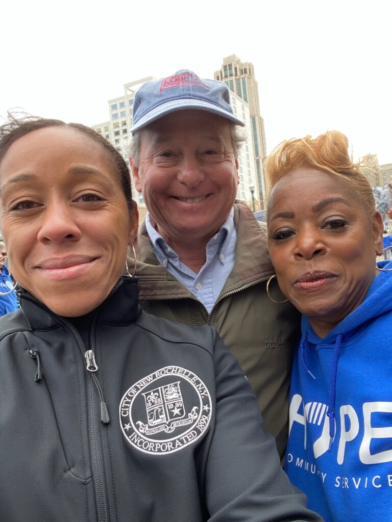 (PHOTO: New Rochelle Mayor Yadira Ramos-Herbert and HOPE Community Services Executive Director Sylvia Hamer with Rye resident and State Assemblyman Steve Otis at the New Rochelle Thanksgiving Day parade. Contributed.)