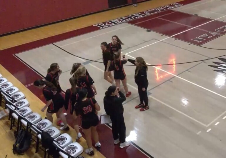 (PHOTO: Rye Girls Varsity Basketball huddles before halftime against Nyack on Tuesday, December 10.)