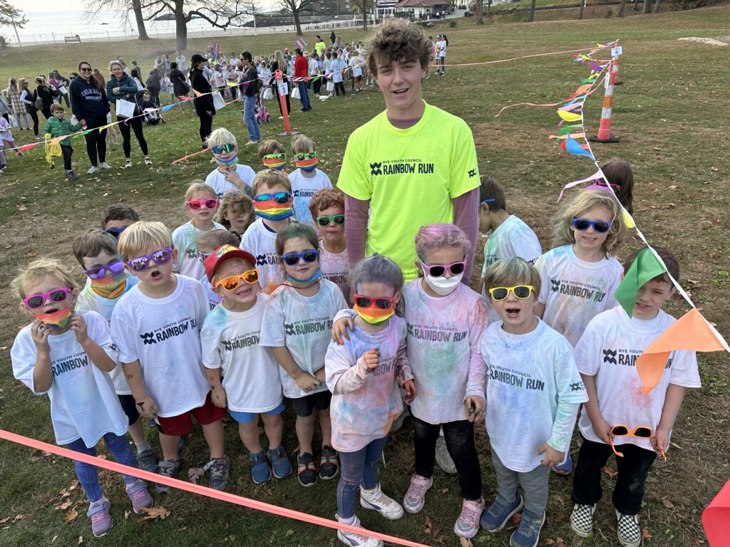 PHOTO: A Rye High School volunteer at the annual Rye Youth Council Rainbow Fun Run for kids in grades K-6 each November.