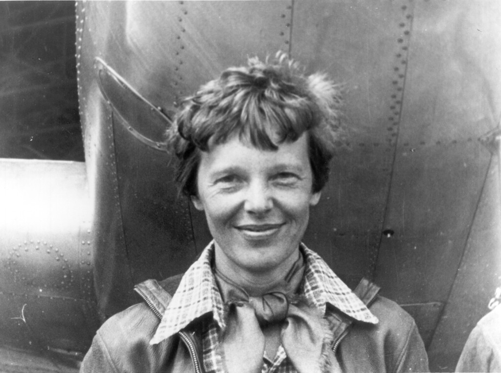 (PHOTO: Amelia Earhart standing under nose of her Lockheed. Contributed.)