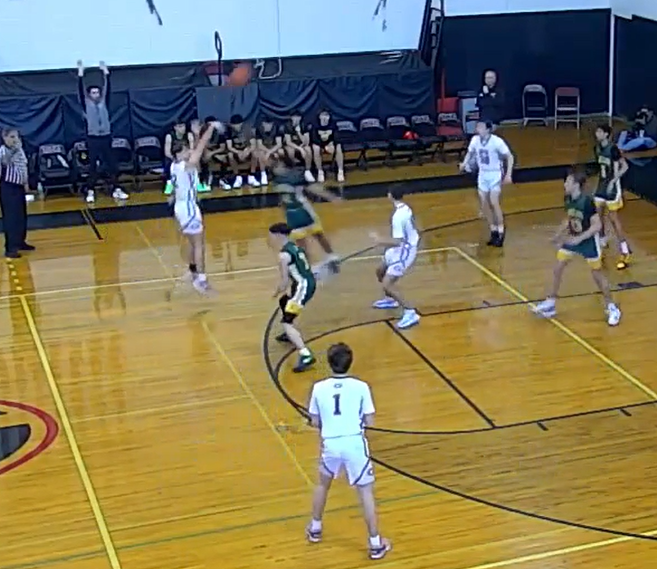 (PHOTO: Rye Boys Basketball's Carson Miller drains a first half three pointer in his team's 55-33 first round victory. Ben Hudson (#1) led the team in scoring in the victory.)