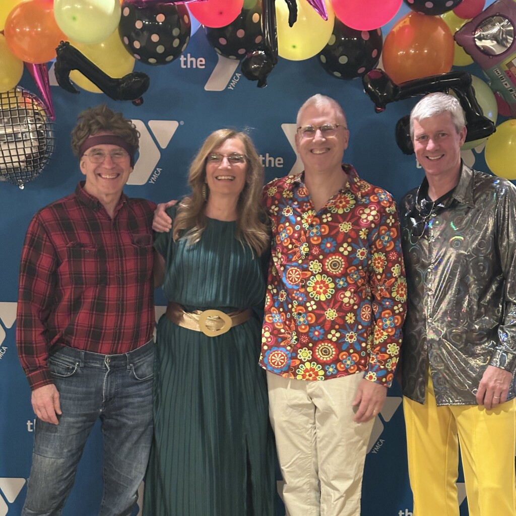 (PHOTO: At the Rye YMCA’s Dancing Through the Decades fundraiser on Friday, February 28, 2025, Community Service Award winner Sam Dimon, Rye Y CEO Sabrina Murphy and Gold Spirit Award winners Jon Elsen and Kevin Kavanagh. Contributed.)