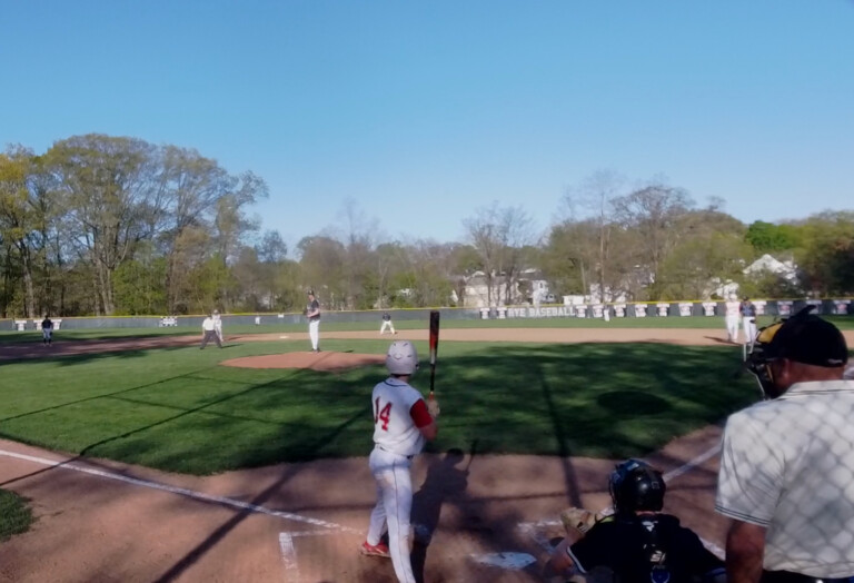 (PHOTO: Rye Baseball's Nolan Hutson (#14) draws an RBI walk in a 12-run second inning vs Edgemont on Monday, April 28. Credit: Game Changer.)