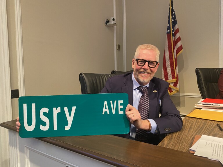 (PHOTO: City Manager Greg Usry was presented with an "Usry Avenue" sign from the City of Rye at his last City Council meeting on March 26, 2025 before his retirement.)