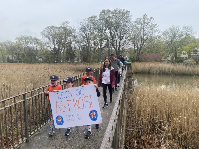 (PHOTO: Crossing the Blind Brook into the back of Disbrow Park at the 68th Annual Rye Little League Parade.)