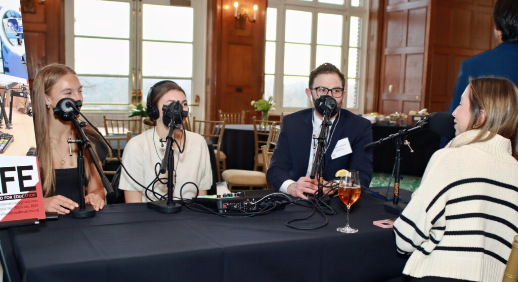 (PHOTO: Rye Fund for Education's annual gala on April 3, 2025 raised over $530,000. RHS students Clare Nemsick & Jessica Mehrara and teacher Anthony Frabizzio, demonstrated their new Newspaper Club podcast equipment. Contributed.) 