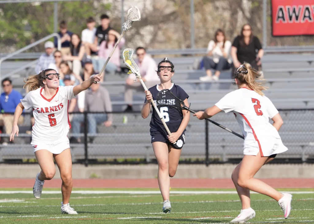 (PHOTO: Ursuline's Maeve Bruton works the ball during girls lacrosse action against Rye at Rye High School on Thursday, April 24, 2025. Rye won 14-6. John Meore/The Journal News)
