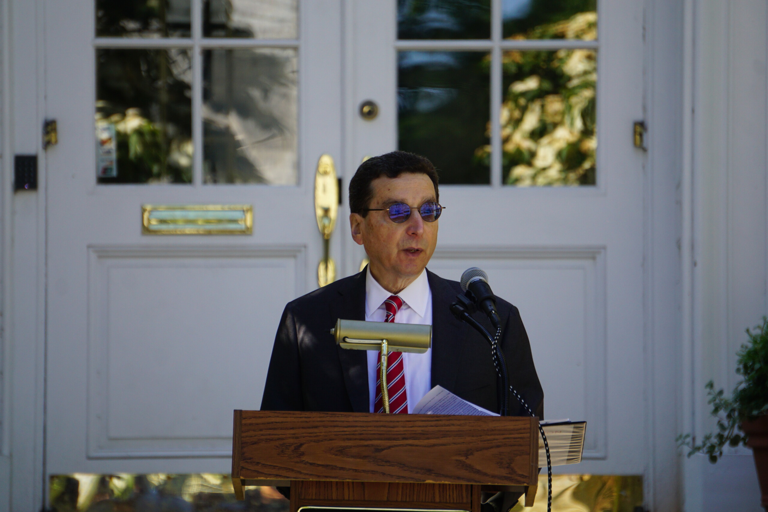 (PHOTO: Memorial Day 2025 in Rye. Rye Mayor Josh Cohn offers remarks during the ceremony on the village green.- Credit: Will Kressler.)