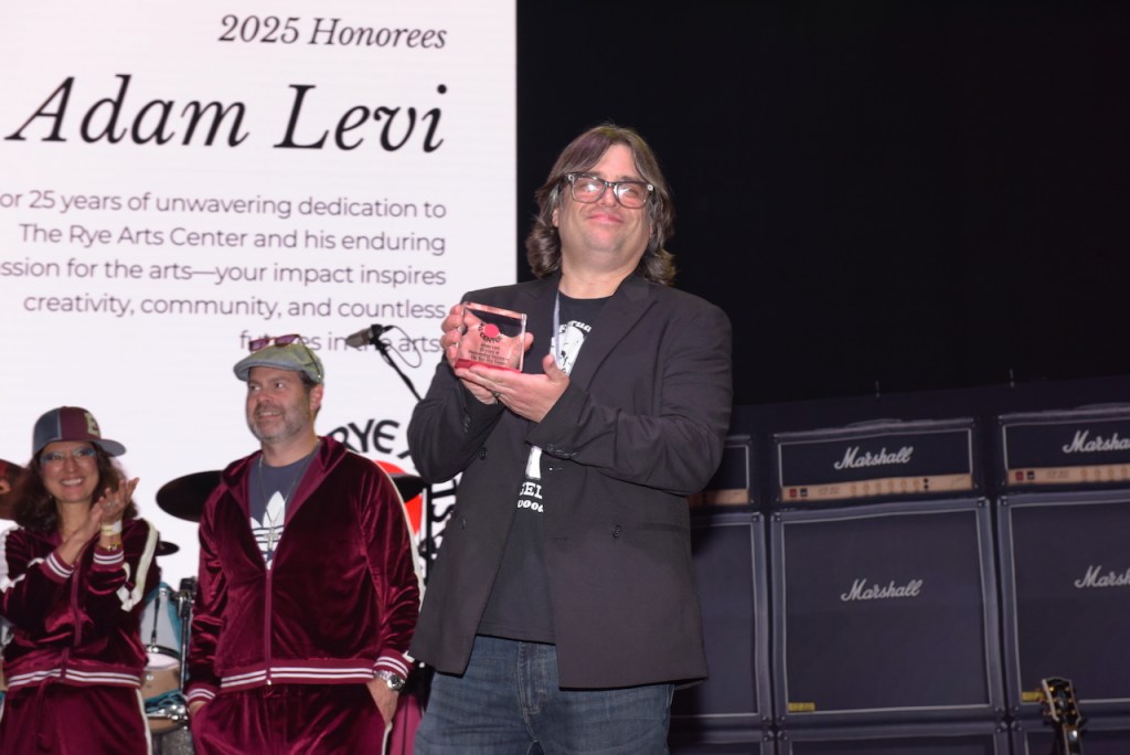 (PHOTO: The Rye Arts Center’s annual benefit Studio 51 on May 15, 2025, raised a record $320,000. RAC Executive Director Adam Levi accepting his award alongside honorees Nicole and Rob Weber. Contributed. Credit: Leslye Smith.)
