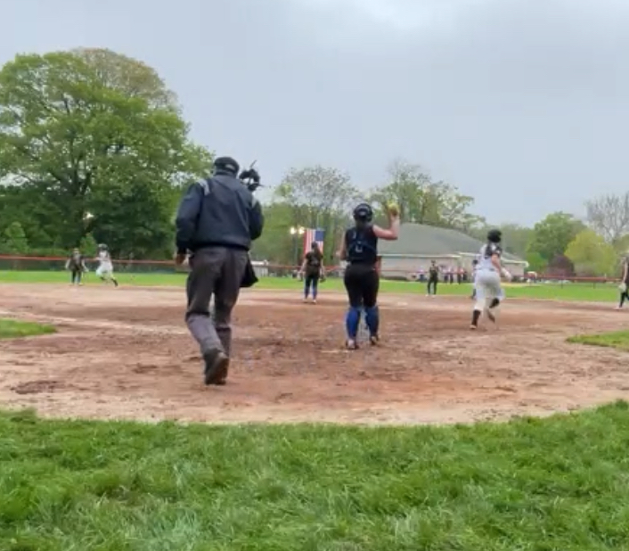 (PHOTO: Rye Softball's Caroline Joyce jogging to first after drawing a game-tying walk against Edgemont on Tuesday, May 6. Credit: Game Changer.)