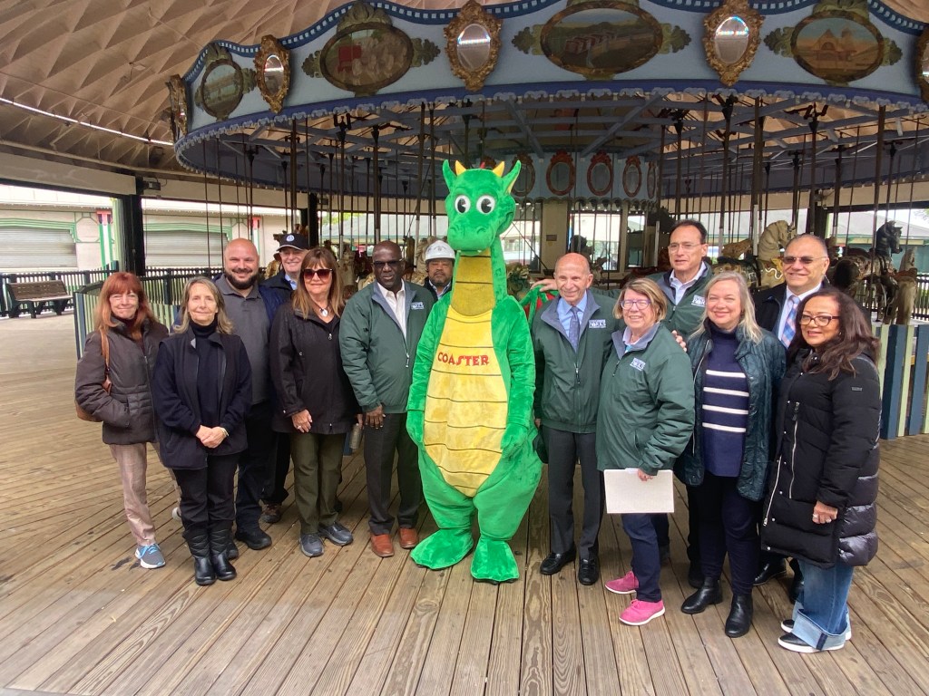 (PHOTO: Westchester County officials and staff with Coaster the Dragon during a Playland Park walk-through on Friday, May 23, 2025.)