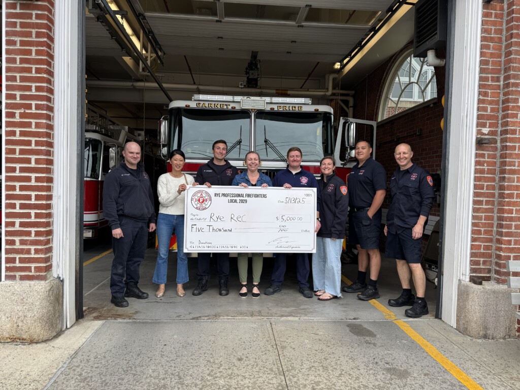 (PHOTO: On Tuesday, May 13, 2025, Local 2029 presented Rye Recreation with a $5,000 grant for their summer camp scholarship fund. Left to right: FF Tyler Conway; Valerie Chuebon (treasurer); FF Daniel Archino; Erin Mantz of Rye Recreation; FF Andrew Wood (board member); FF Cea Fong (board member); Cristian Acevedo (board member); Sal Inguanti (president). Contributed.)