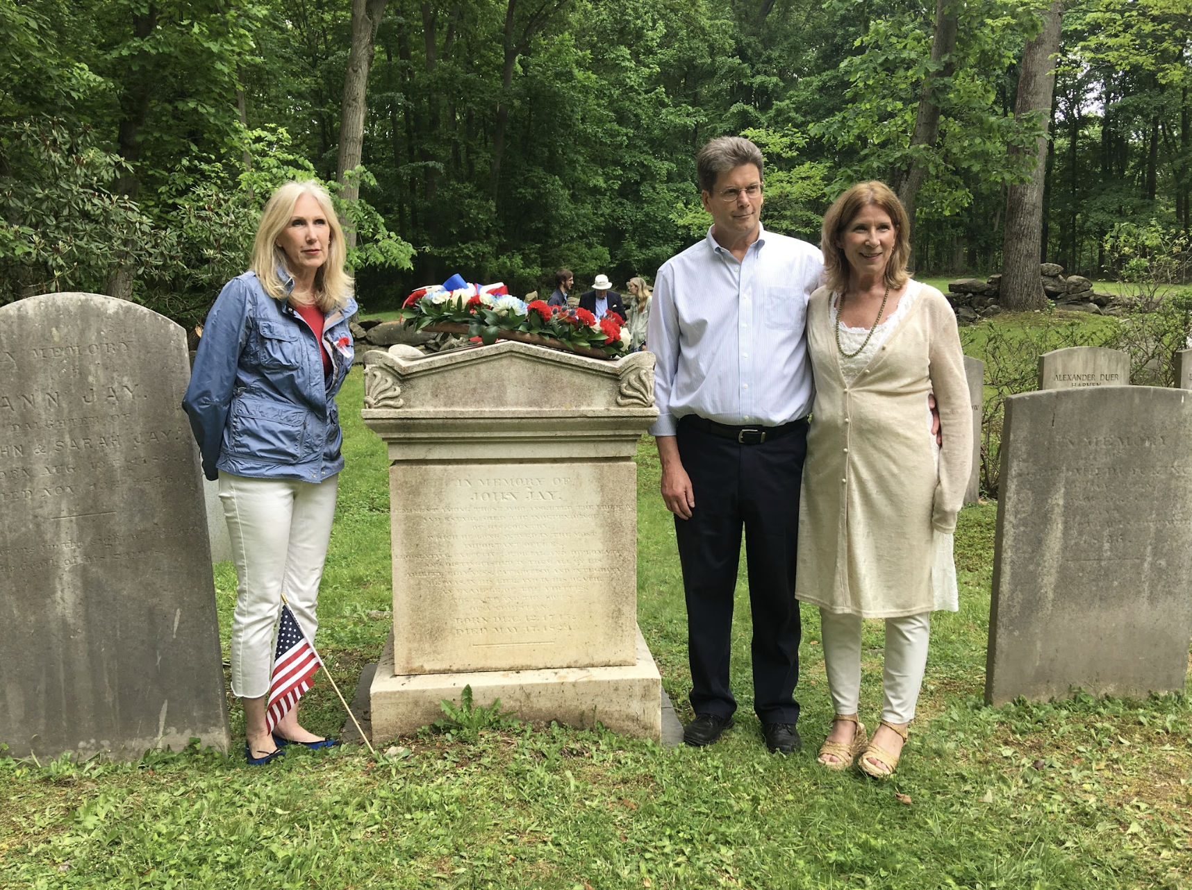 (PHOTO: Suzanne Clary of the Jay Heritage Center with Mr. and Mrs. Peter Doane of the Jay Cemetery at gravesite of John Jay in 2018.)