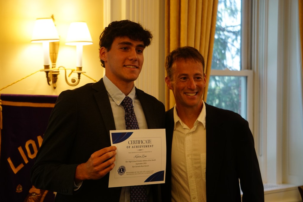 (PHOTO: Rye Varsity Soccer player Kaden Zion with Coach Jared Small at the Rye City Lions Club 27th Annual Scholar Athlete of the Year on June 12, 2025. Credit: Will Kressler.)