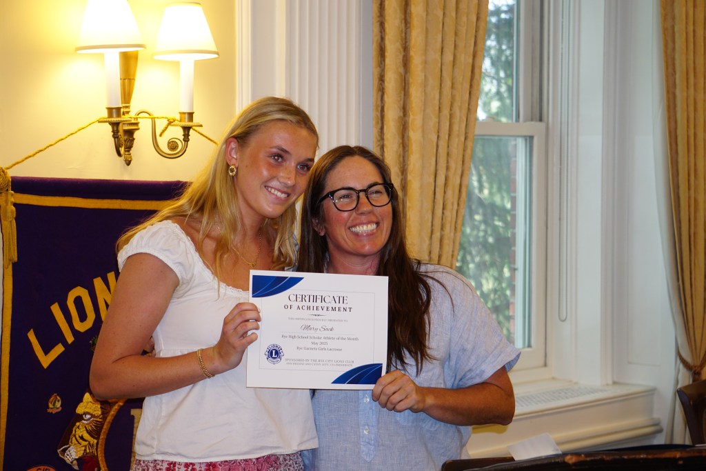 (PHOTO: Rye Varsity Girls Lacrosse player Mary Sack with Coach Michelle Mason at the Rye City Lions Club 27th Annual Scholar Athlete of the Year on June 12, 2025. Credit: Will Kressler.)