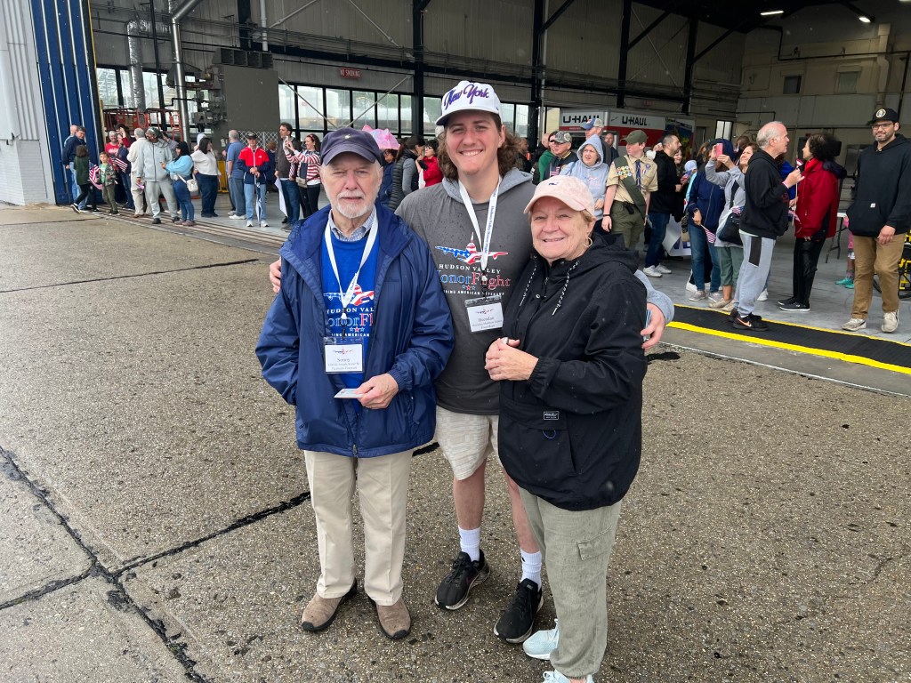 (PHOTO: Seven Rye veterans participated in an honor flight to Washington, D. C. on Saturday, May 31, 2025. Sonny Slater, Brendan Hickey, Ellen Slater at the Honor Flight Send-off. Contributed.)