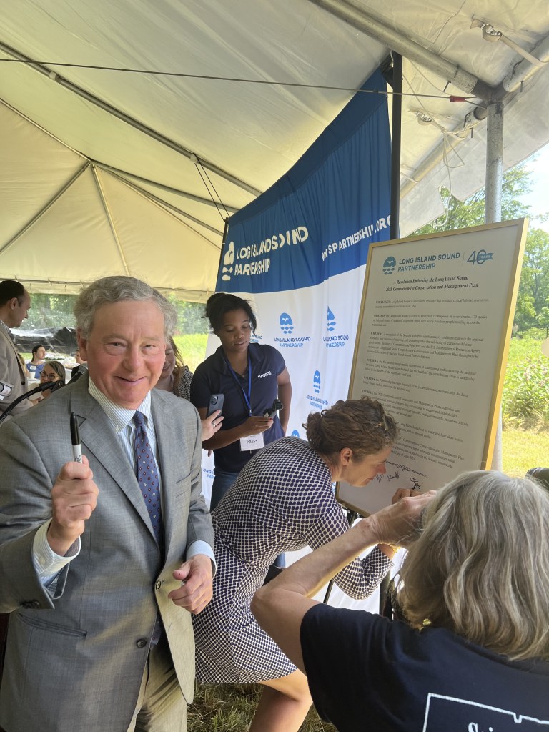 (PHOTO: Assemblyman Steven Otis of the 91st District (left) and Commissioner Katie Dykes (right) signing the new LISP plan. June 20th, 2025. Credit: Beatrice Larzul.)