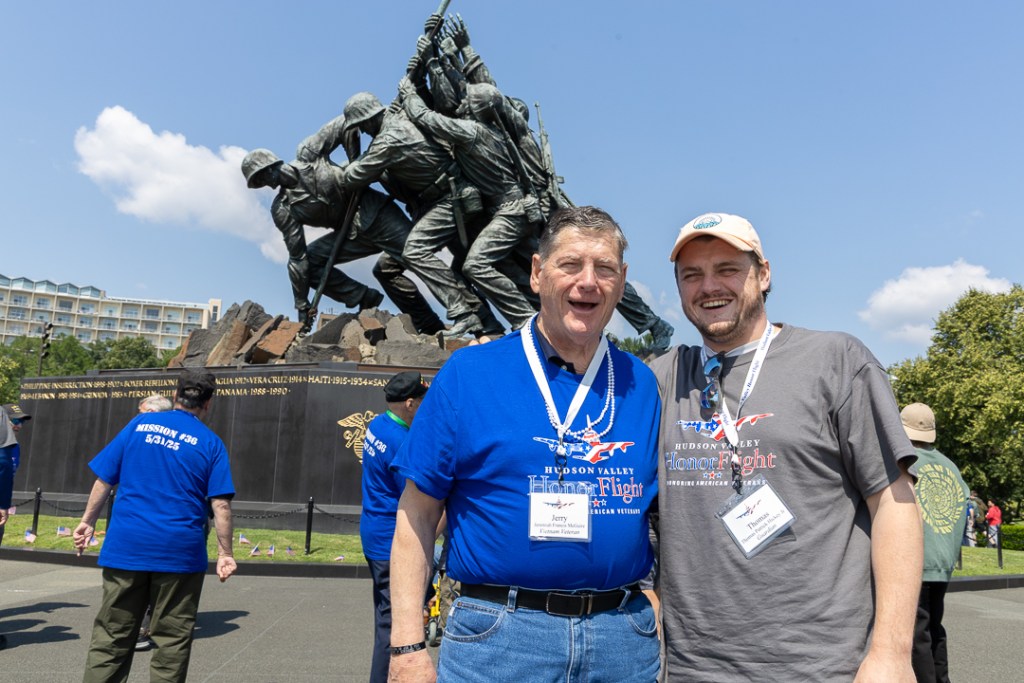 (PHOTO: Seven Rye veterans participated in an honor flight to Washington, D. C. on Saturday, May 31, 2025. Jerry McGuire and grandson Thomas McGuire at the US Marine Corps War Memorial. Contributed.)