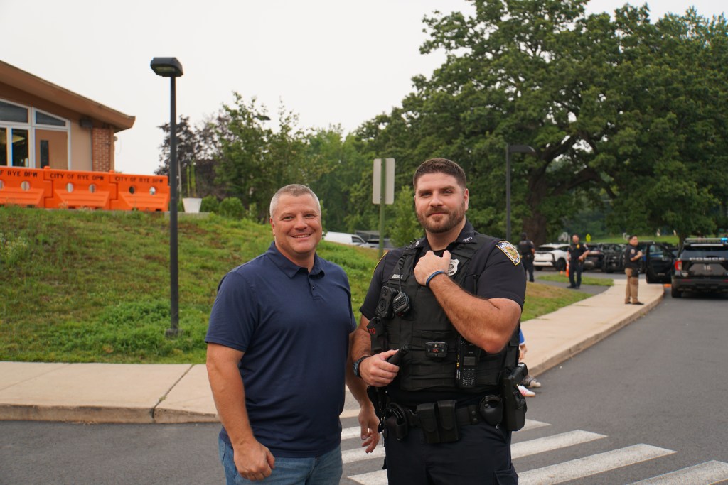 (PHOTO: Rye PD held its third annual National Night Out on August 5, 2025 at Rye Recreation. Rye FD Captain Clyde Pitts and PO Joshua Belloise. Credit: Eli Chopra.)