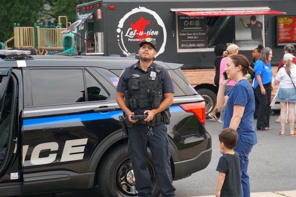 (PHOTO: Rye PD held its third annual National Night Out on August 5, 2025 at Rye Recreation. PO Luis Torres flies the department's drone. Credit: Eli Chopra.)