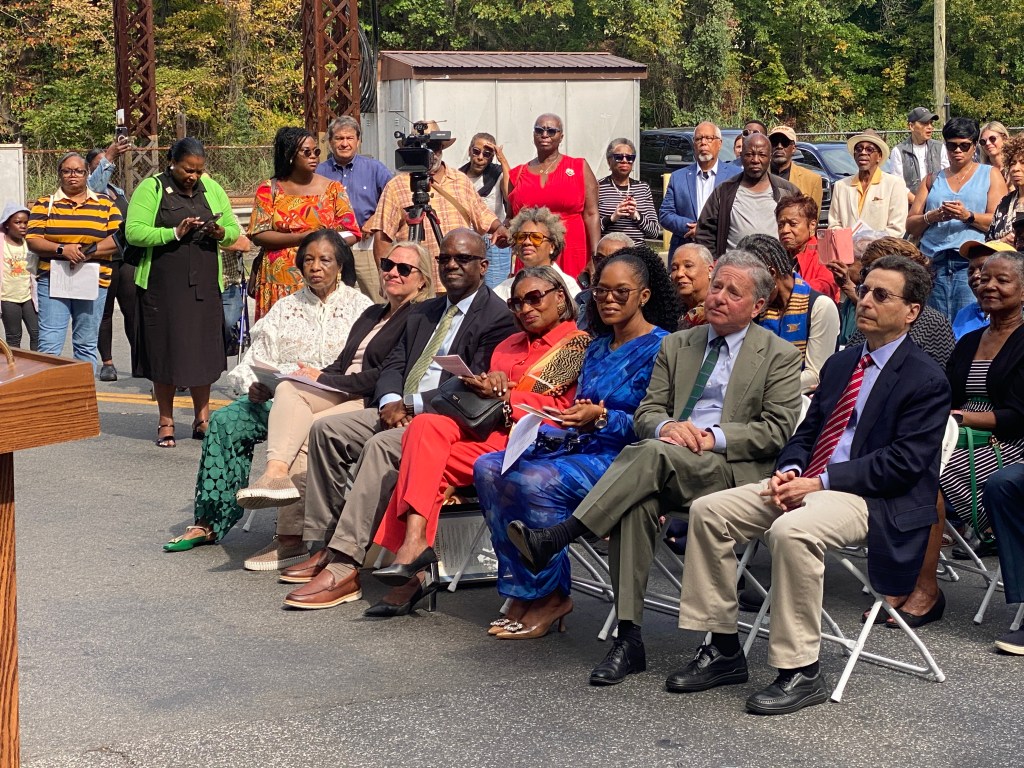 (PHOTO: The Paul & Orial Redd Way street naming at the Rye train station on September 27, 2025. VIPs in the front row and the assembled crowd.)