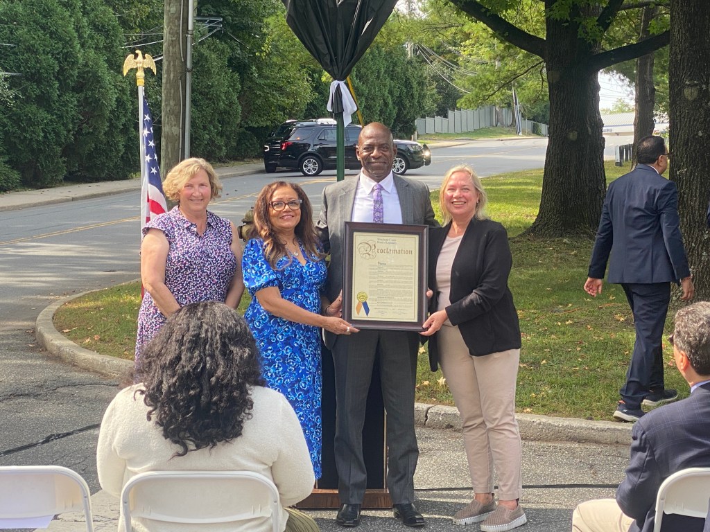 (PHOTO: The Paul & Orial Redd Way street naming at the Rye train station on September 27, 2025. Westchester Legislator Catherine Parker (right) and her colleagues presented a proclamation to Paul Redd Jr.)