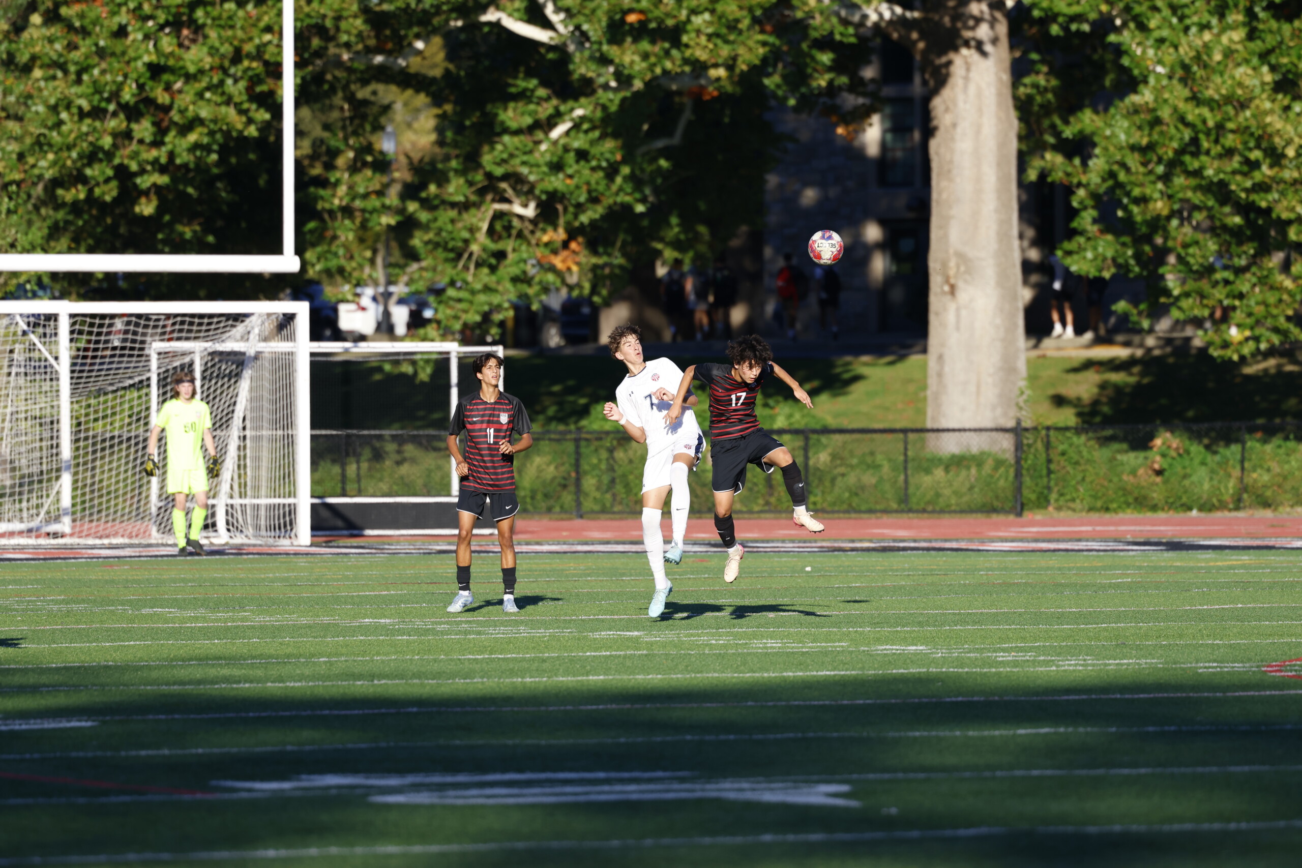 (PHOTO: Rye Boys Soccer's Shun Nagata (#17) goes for a header in his team's 3-1 win over Eastchester on Thursday, September 18. Credit: Alvar Lee.)