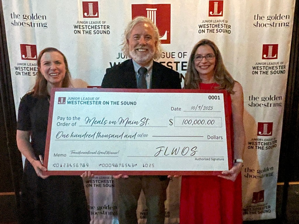 (PHOTO: Caroline Vance (Junior League of Westchester on the Sound (JLWOS) grants chair; Jon Haseltine, executive director of Meals on Main Street Port Chester (accepting the $100K Transformational Grant for a first of its kind mobile community cafe); and Chris Howe, JLWOS president. Contributed.)