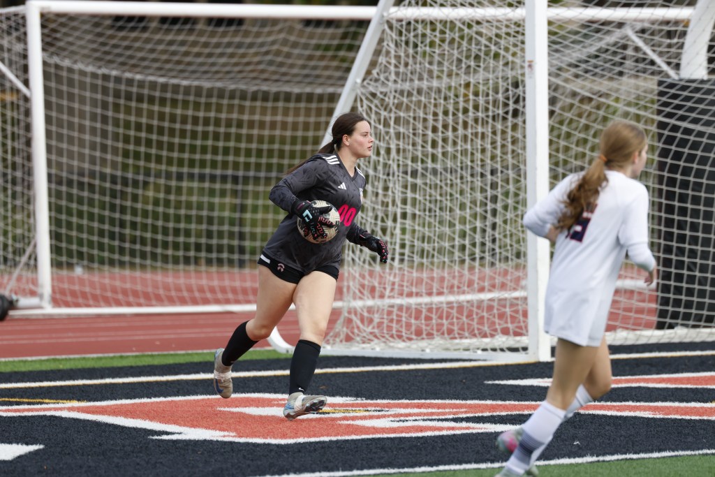 (PHOTO: Goalie Tessa Labowitz doing the work. Rye Girls Varsity Soccer came out fast and furious to capture a 4–0 win over league rival Byram Hills on October 18, 2025 and finish the regular season as undefeated league champions. Credit: Alvar Lee.)