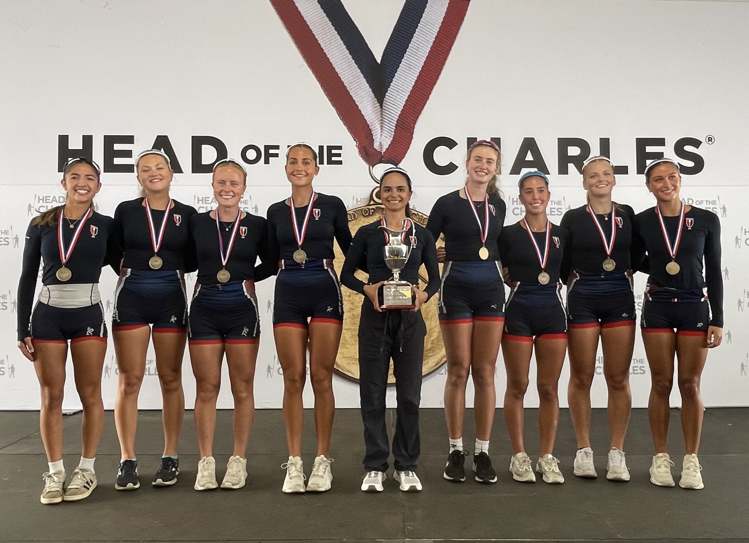 (PHOTO: The RowAmerica Rye Girls Youth Eight (A Boat) won their event for the fourth consecutive year. The boat is comprised of Gwendolyn Leites, Sophie Lamberg, Sydney Perez, Zoe Perota, Marlena Masucci, Kiera Setness, Lulu Ploog, Molly Peacock, Remy Hess. Contributed.)
