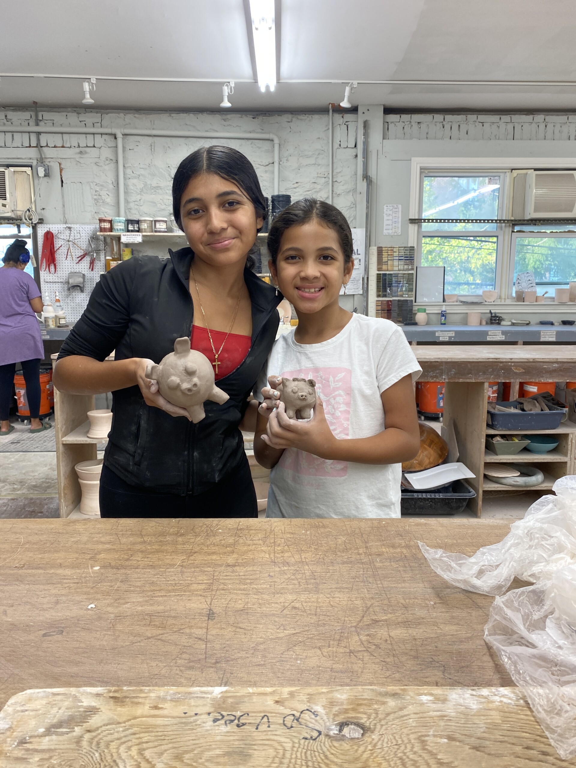 (PHOTO: Clay Arts Center students showing off their ceramic creations at the Hispanic Heritage Month Class. Contributed.)