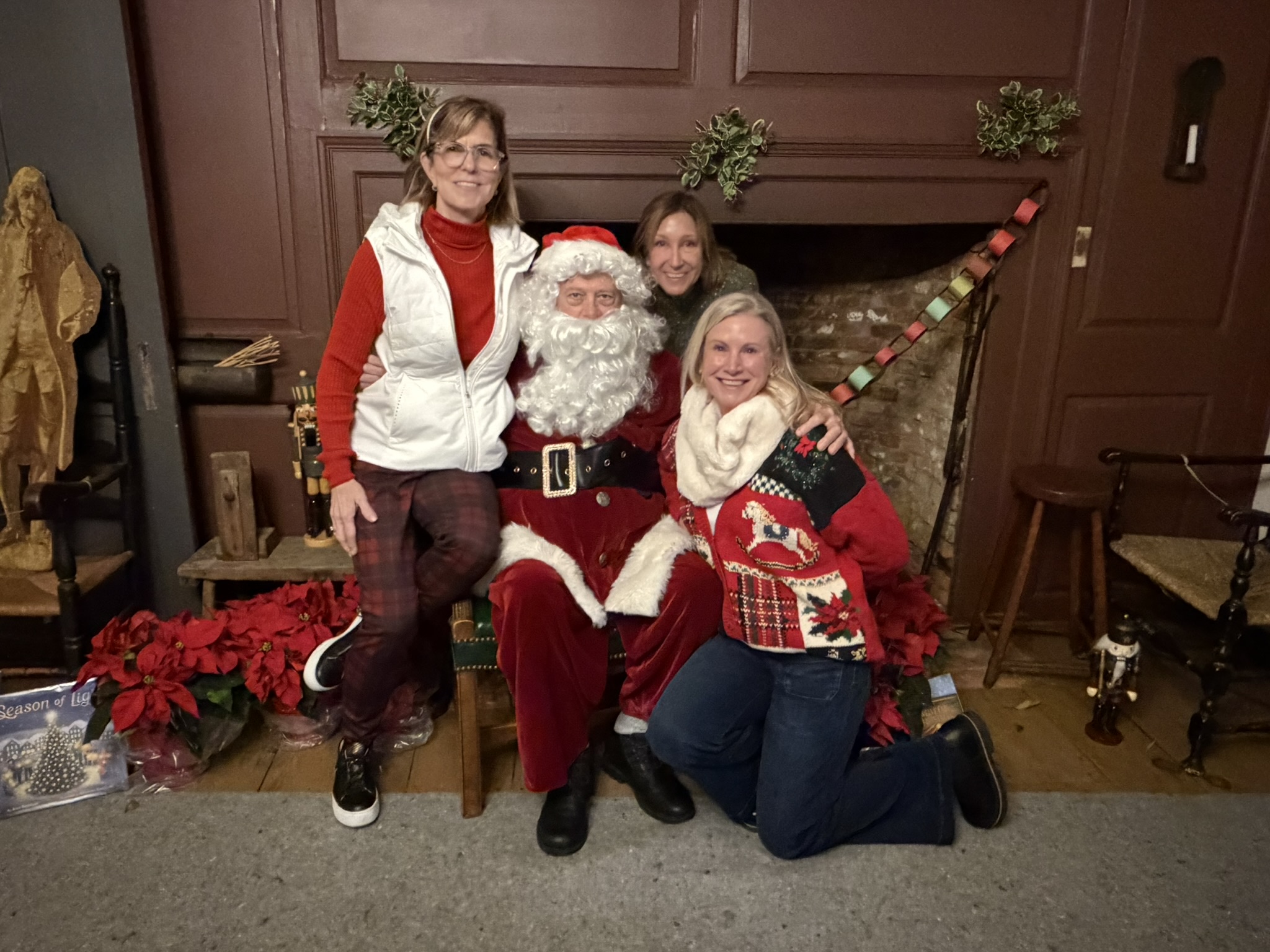 (PHOTO: The Season of Giving celebration at the Square House on November 30, 2025, organized by the Rye Historical Society. Santa Claus appeared in his finest Garnet red suit. He he appears with some of his elves.)