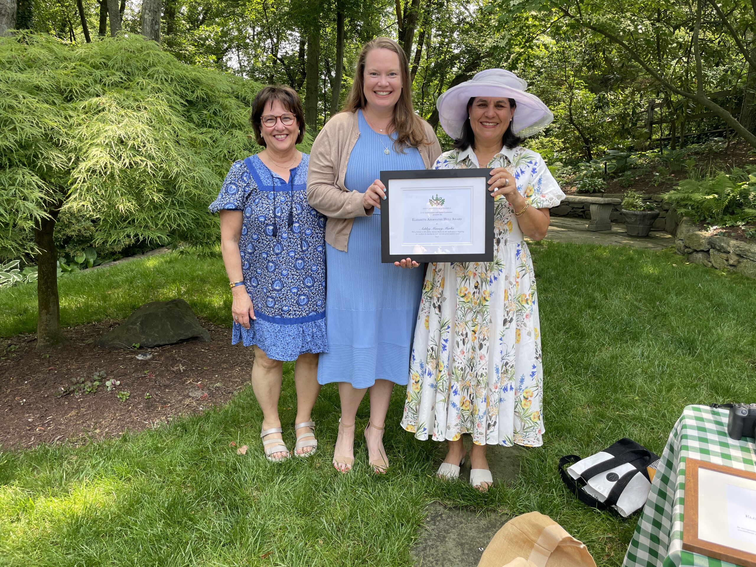 (PHOTO: Dr. Ashley Marks, a teacher at Holy Child (center), received the Hull Award from the Little Garden Club of Rye. Left to right: Toni Archibald, LGCR member and director of community engagement, special events at Holy Child; Marks and Rosario Benavides Gallagher, the outgoing president of LGCR. Contributed.)