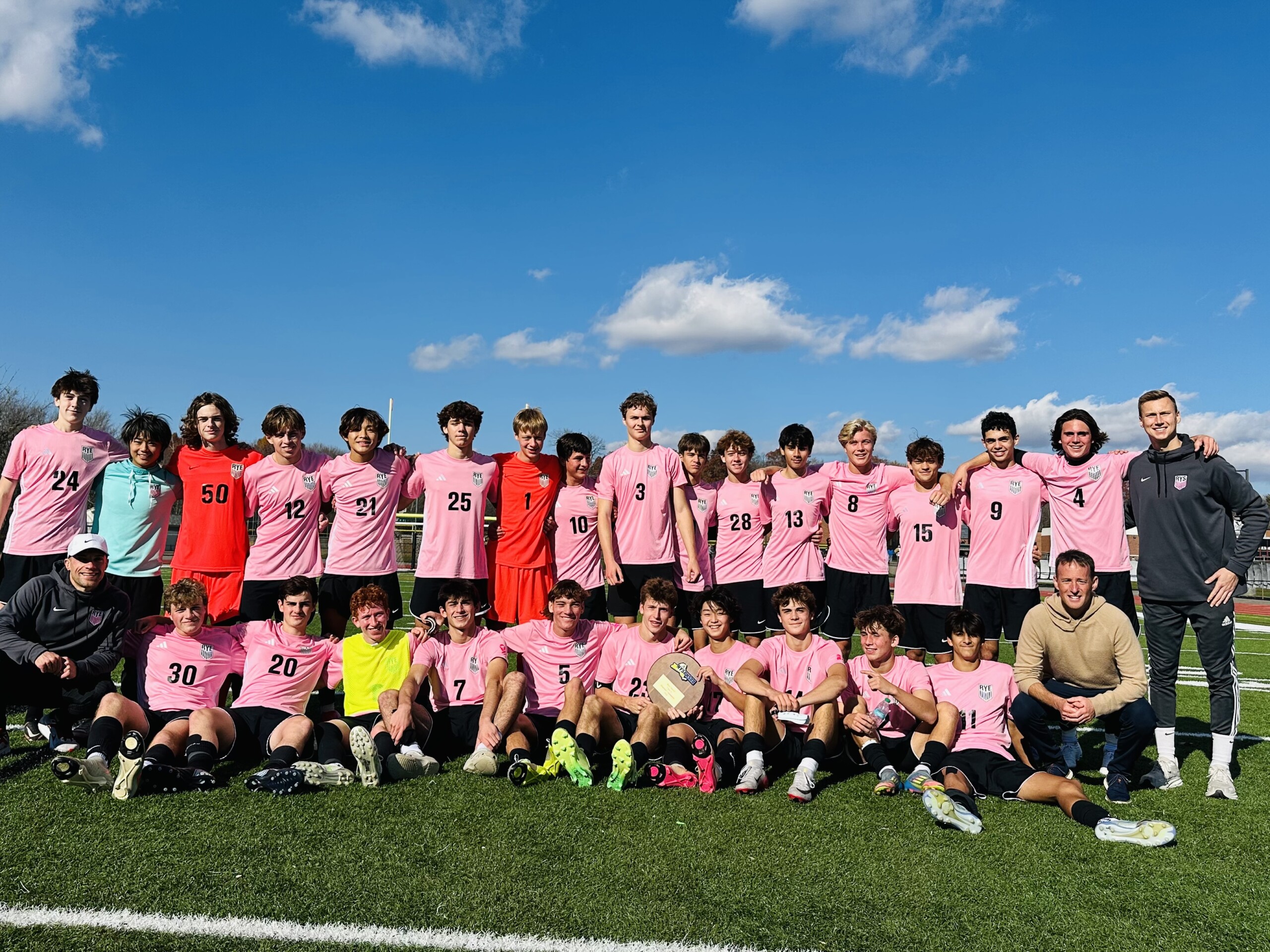 (PHOTO: The 2025 Rye Boys Soccer team posed with their Regional Championship plaque. Credit: Daniela Kehoe.)