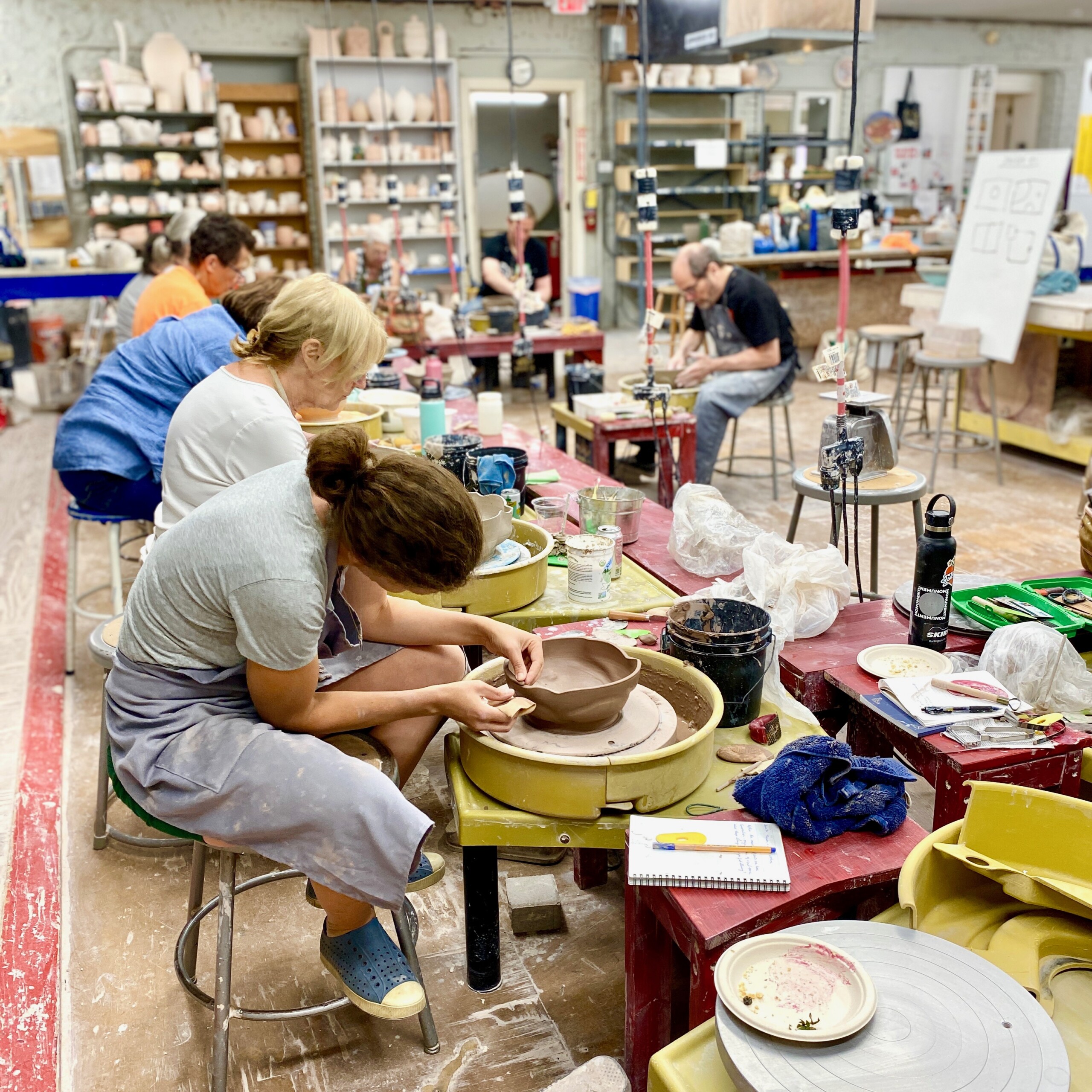 (PHOTO: Students at the Clay Arts Center participating in a pottery class. Contributed.)