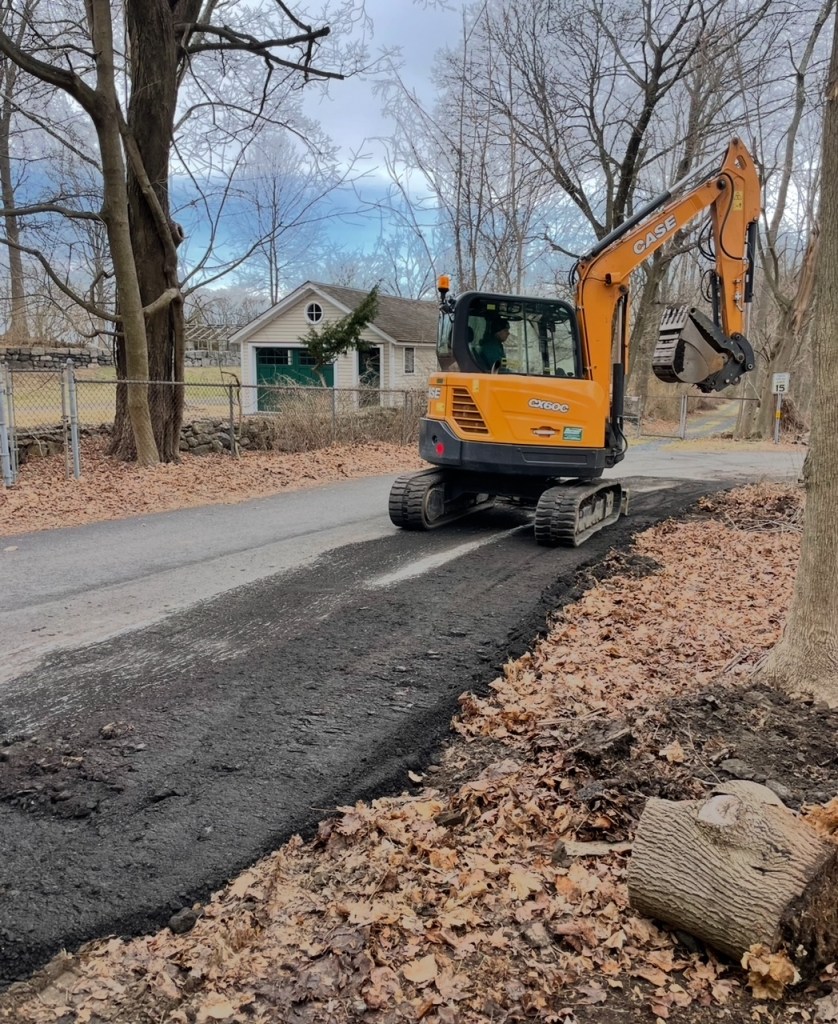 (PHOTO: Jay Heritage Center (JHC) officials maintain County work has already begun at the Marshlands Conservancy, including an attempt to widen the Cemetery Lane - owned by the Jay Cemetery Association, not the County. JHC says this photo, from 2023, shows road work on the Jay Cemetery lane to double the width and pave it. They say property lines were ignored as the County used an outdated 1971 survey. Source: Jay Heritage.)
