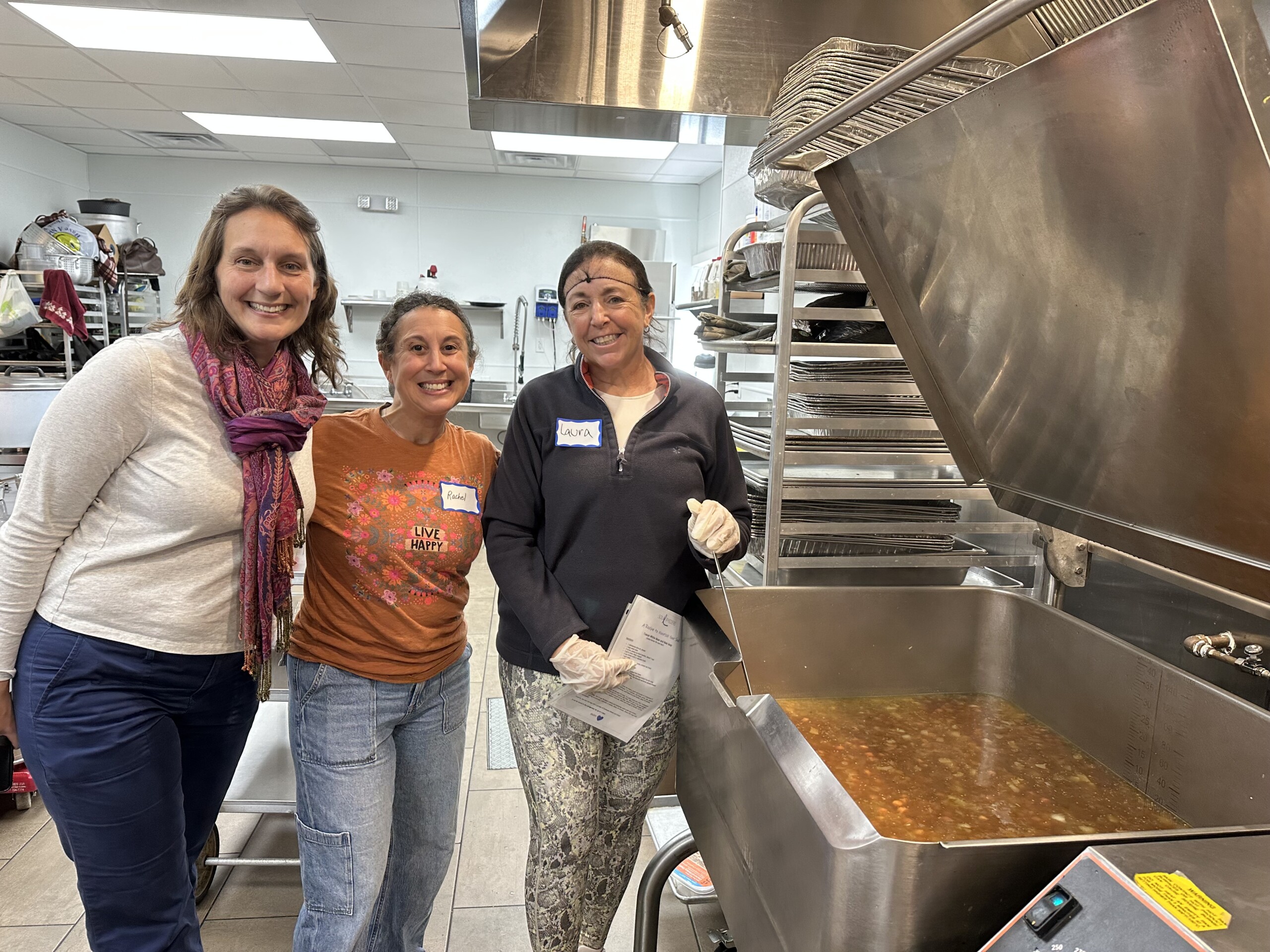 (PHOTO:Heidi Kitlas, Rachel Felenstein - volunteer program manager, and Laura Longo - longtime volunteer, cooking and baking for client care packages at the Meals on Main Street kitchen in Port Chester. Contributed.)