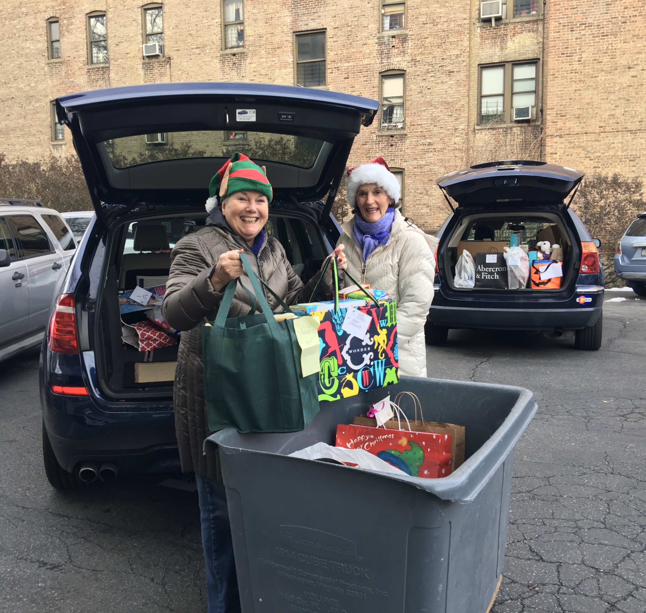 (PHOTO: Pat Geoghegan (left) and Barbie Haynes (right) of Houlihan Lawrence making a Holiday Angel delivery to a shelter in the Bronx. Contributed.)