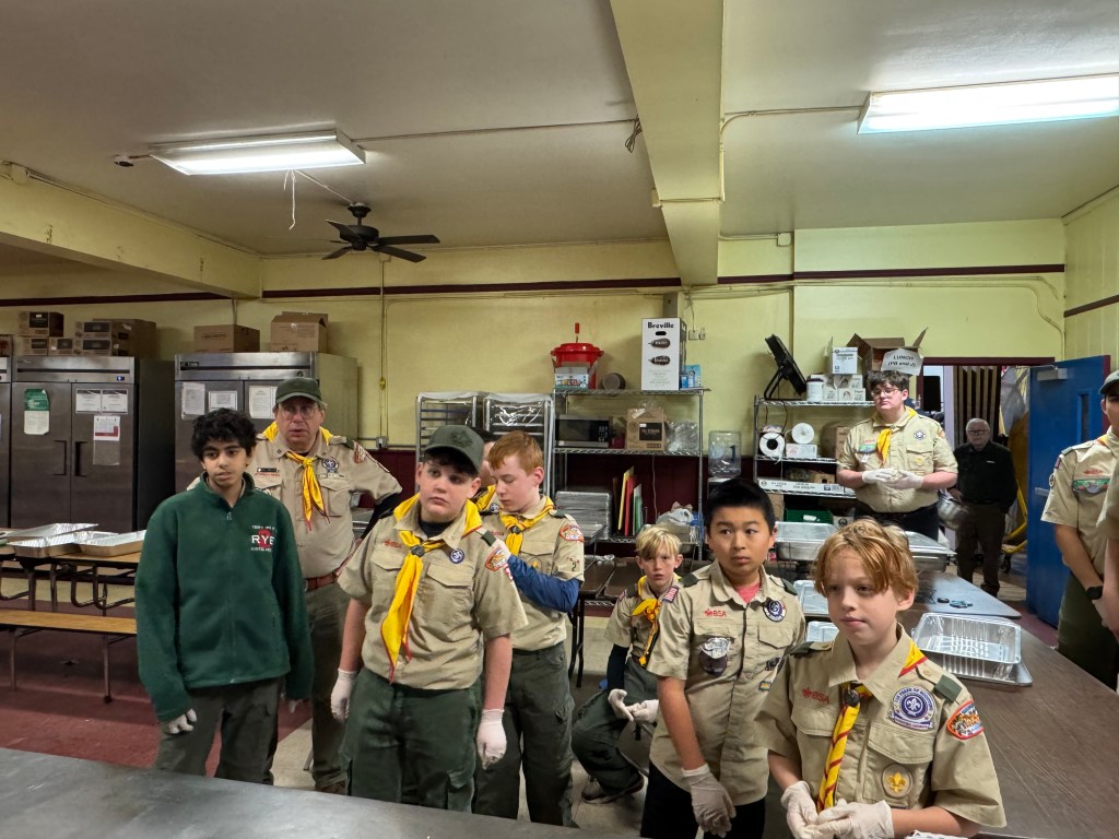 (PHOTO: Santa Claus was at the Don Bosco Community Center in Port Chester for a special annual breakfast attended by over 800 people on Saturday, December 13, 2025. Scouts from Rye Troop 2 were some of the many volunteers contributing to the success of the day. Contributed.)