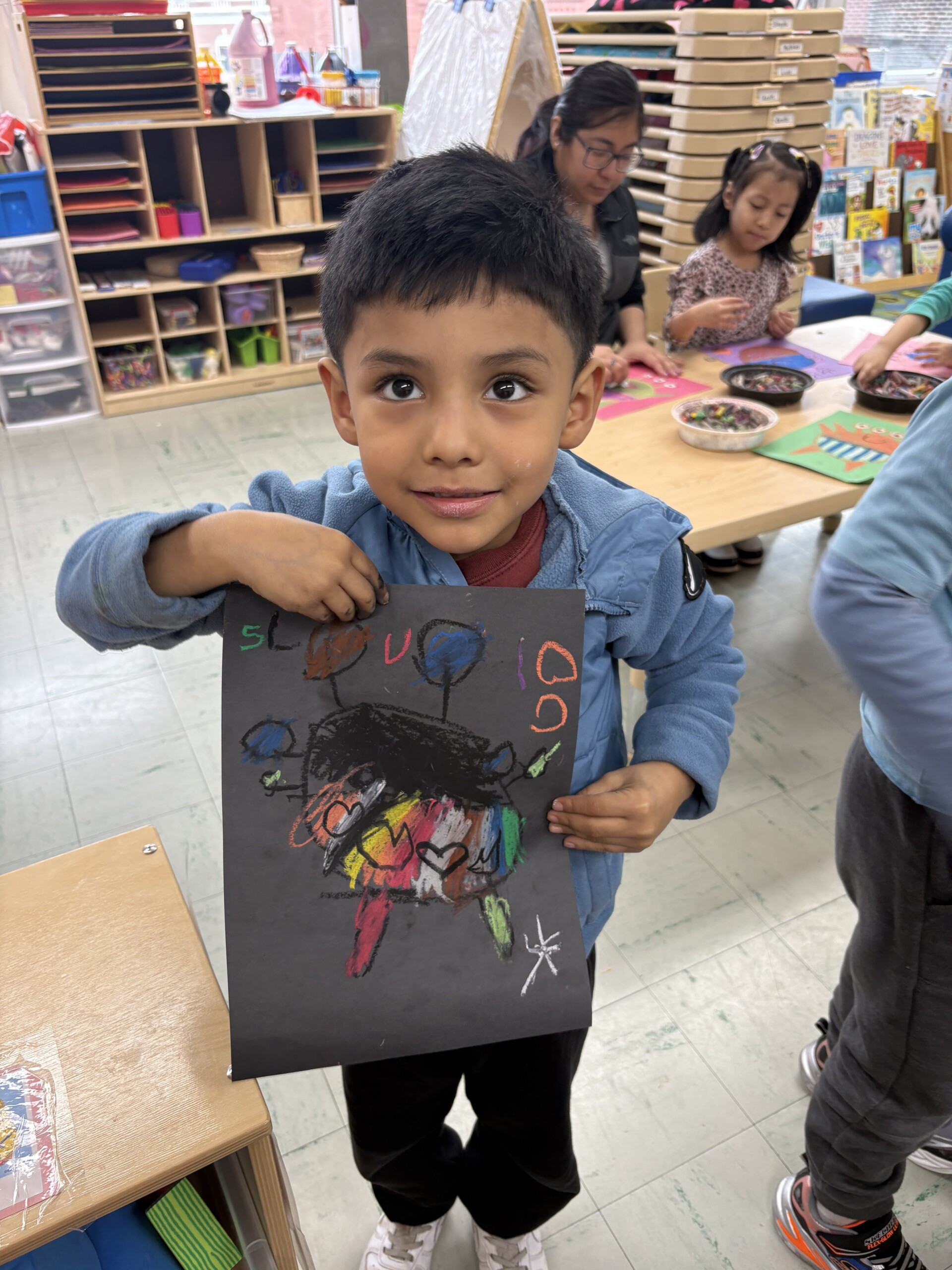 (PHOTO: A young student creates artwork in a Port Chester Headstart class taught by beloved RAC community member, professional artist, and teacher Terry Taylor. Contributed.)