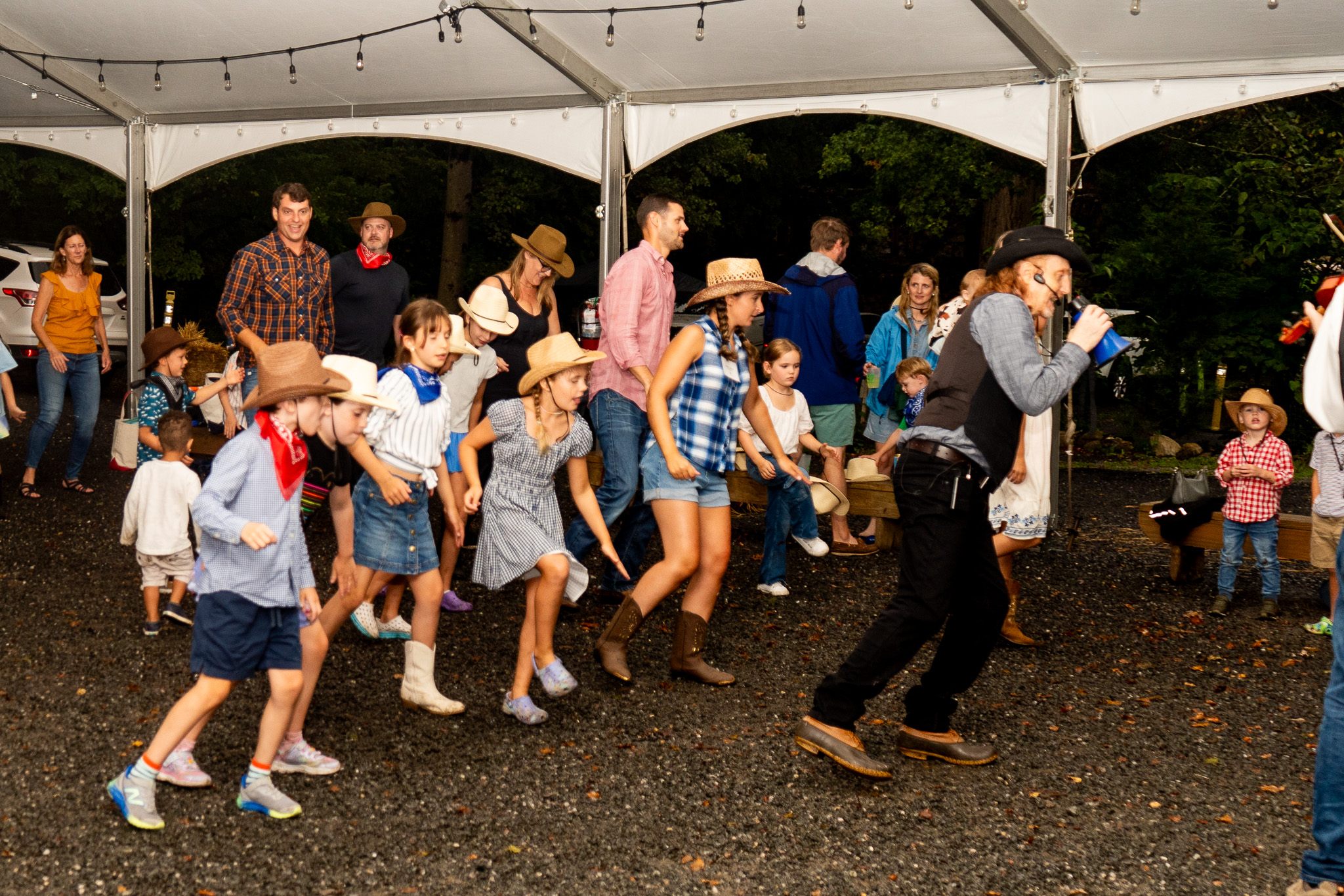 (PHOTO: Professional caller Dance with Lance leads the crowd in a traditional square dance at Rye Nature Center’s Octoberfest. Contributed.)