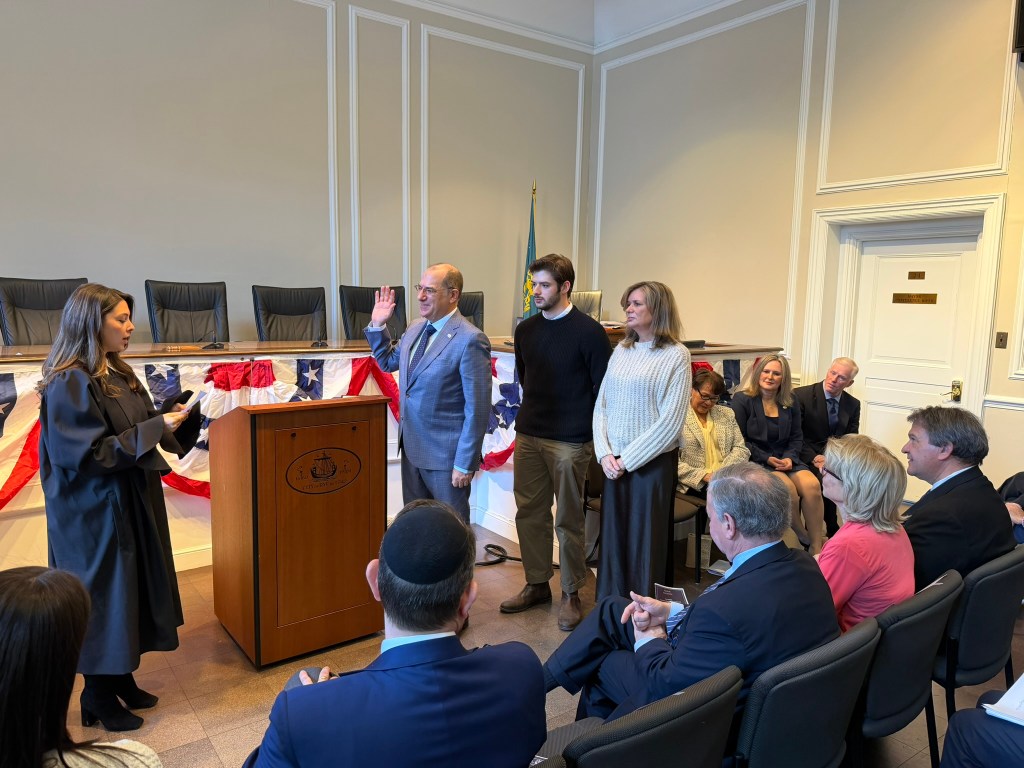 (PHOTO: The City of Rye inauguration ceremony on January 4, 2026. Newly elected Rye Mayor Josh Nathan being sword in by the Judge Taylor Piscionere. Nathan was joined by his wife Pam and son Hal.)