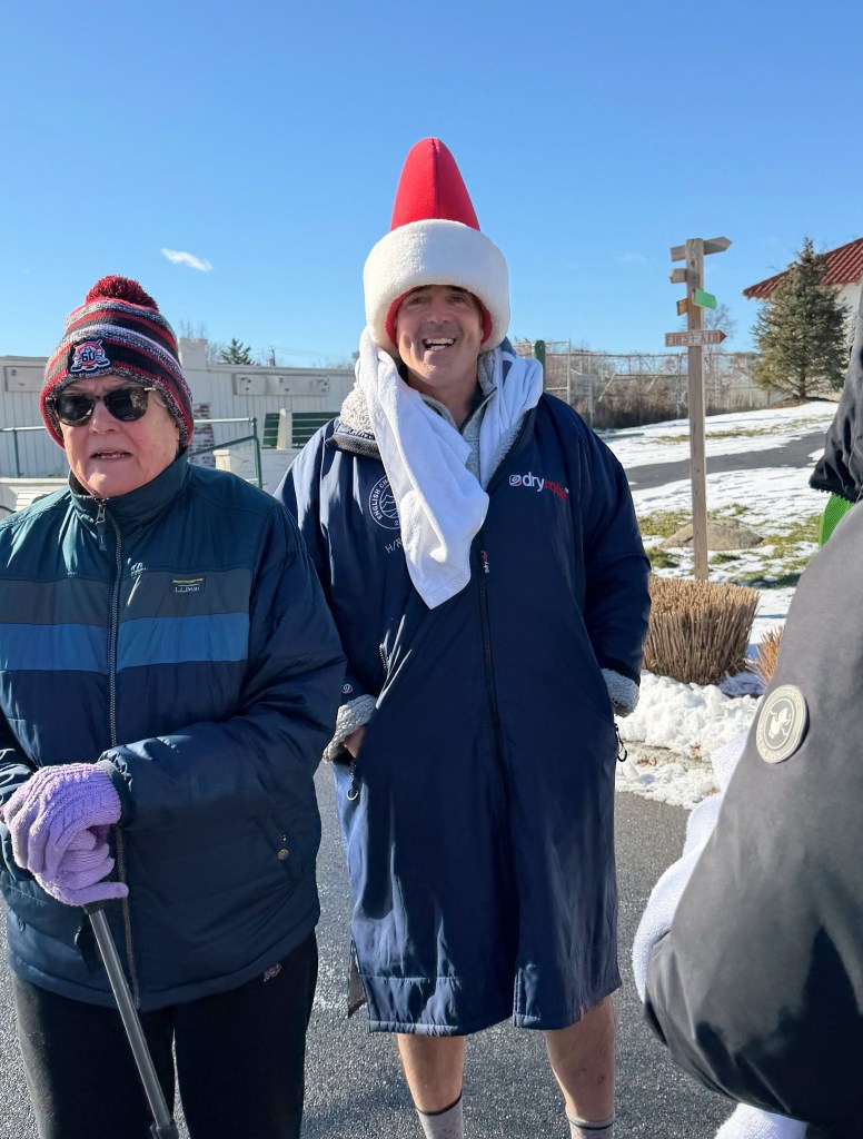 (PHOTO: 203 people participated in the 26th annual Polar Plunge at Oakland Beach in Rye on Thursday, January 1, 2026. The event money for local charities Soul Ryeders and Meals on Main Street. Jake Dolci in the Santa hat recently swam the English Channel. Contributed.)