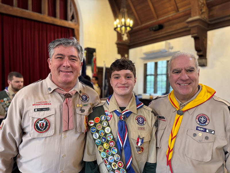 (PHOTO: Rye Troop 2 celebrated its 100th Eagle Scout. Mark Pellegrini had his Eagle Court of Honor on Saturday, January 3, 2026. Pellegrini with his first scout master Paulo Zangiacomi and District Commissioner Ray Quartararo. Contributed.)