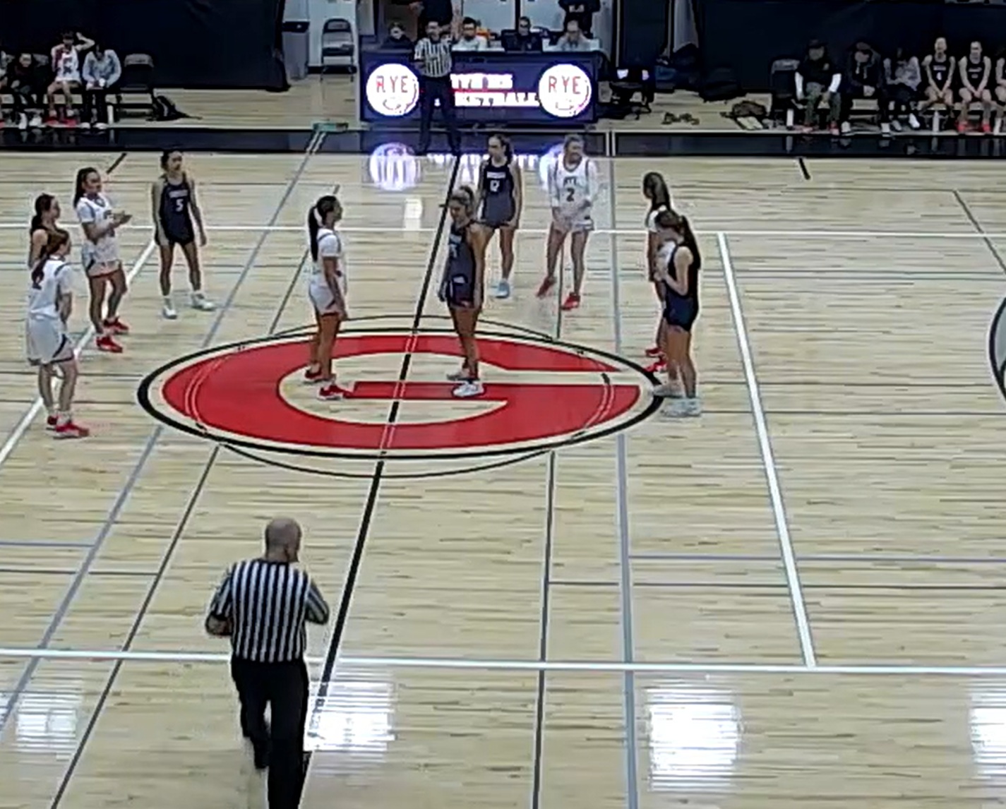 (PHOTO: The Rye Girls Basketball team in white lined up for pregame tip-off vs Horace Greeley on January 21, 2026.)
