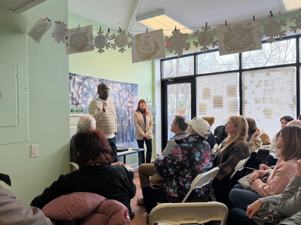 (PHOTO: Westchester County Executive Ken Jenkins and Robin Latimer, the chair of the new Friends of Rye Playland group, speak with attendees at the group's inaugural meeting on Saturday, February 7, 2026.)