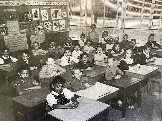 (PHOTO: 4th Grade Osborn School in Rye, NY,1964. Row 1: Adrianne Thomas, Greg Choron, Marc [?], Barbara Luna, Cory Kaiser, Andy Schuster ; Row 2: Marion Anderson, John Fanning, Philip LeBrun, Todd Newcomb, Angel Bardani, Vicki Mira (headband), Alex [?], Barbara Blumenschine, Laura Gordich, Joe Picone; Row 3: Joe Seftner; Row 4: Judy Santucci, Jim Fuller, Mike Tedesco, Sue Mantz Henry Knoop (left of teacher), Barabar Johnson (next to teacher by window). Contributed.)